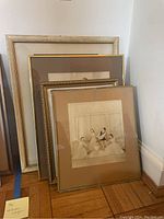 Four ballet artwork pieces framed and leaning against wall showing varying frame styles and mat colors.