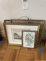 Group photo of the three framed prints leaning against a wall, showing scale and frame styles.