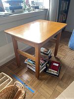 Full view of the wooden desk showing its top surface, legs, and casters.