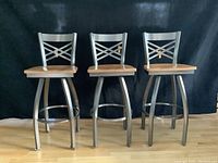 Three stools displayed side by side showing frame finish and seat color