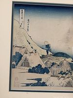 Close-up of lower left section of print showing huts and figures