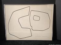 Framed abstract art showing two black outlined forms on cream background, signed lower right.