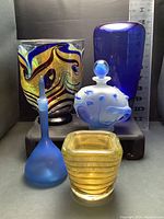 Five handmade art glass pieces including perfume bottles, a bowl and vase