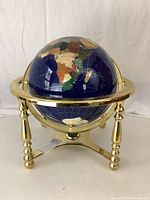 Front view of globe and brass stand showing full structure