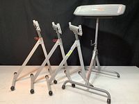 Three HDX infeed roller stands side by side showing adjustable height and roller wheels