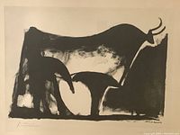 Close-up of “The Black Bull” print showing bold black brushstroke silhouette of bull on off-white paper