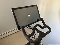 Angled view of bike showing 21.5-inch touchscreen and drop-style handlebars