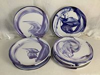 All ten plates stacked with some displayed to show swirl patterns