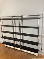 Full assembly of three shelving units mounted on wall