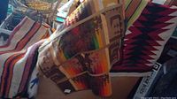 Overview of folded horse blanket and tapestries in garage