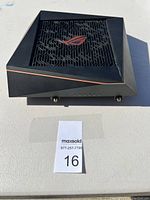 ASUS ROG router top side showing vented black surface with red logo and angular edges