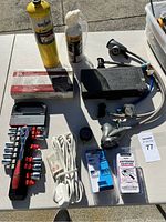 Overview of all items including propane torch, radiator heater, socket set, extension cord, adapters and spray canister.