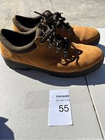 Side view of Timberland shoes showing brown leather upper and laced closure