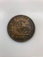 Front side of the 1857 Upper Canada penny showing horseman slaying dragon and dated 1857