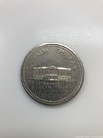 Reverse side depicting a building representing Prince Edward Island with inscriptions 'Canada Dollar' and '1873 Prince Edward Island'.