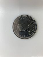 Obverse side of 1984 Canadian one dollar coin showing Queen Elizabeth II profile and inscriptions including date and denomination.
