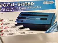 Box showing product name, features including 5 page capacity, ultra-thin strips, auto start and stop, reverse switch, ideal for home or office use.