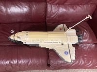 Photo of completed NASA space shuttle model made of white, black and beige Mega Bloks.