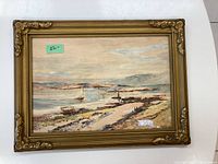 Full view of one framed watercolor showing a coastal scene with boats and a shoreline path.