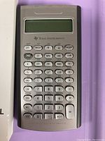 Close-up photo of the Texas Instruments BA II Plus financial calculator showing keys and display.