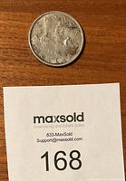 Close-up of the reverse side of the 1960 Canadian silver dollar coin showing the Voyageur design with canoe and the text 'CANADA DOLLAR 1960'.