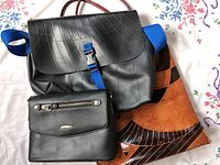 Three purses displayed together on floral fabric background, showing material differences and design