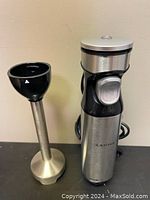 Complete set of A-KISSEE hand blender including the motorized handheld blender body and the detachable blending shaft showing stainless steel and black plastic.