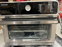 Front view of the Cuisinart CTOA-130 air fryer toaster oven showing stainless steel finish, black control panel with function dial and cooking presets.