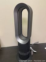 Front view of unit upright on table showing loop amplifier and base