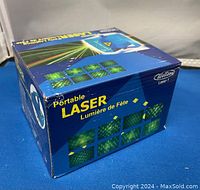 Box of Wellson Portable Laser Party Lighting showing product branding, graphics, and laser light pattern examples.