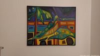 Framed abstract painting on canvas hanging on the wall showing full view