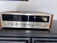 Front view of receiver showing silver faceplate, display window and control knobs