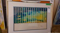 Full view of the framed watercolour painting with vertical white bars over colorful abstract background.
