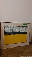 Full view of the framed abstract painting showing composition and colors.