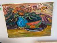 Framed painting depicted on a wall showing abstract still life with vase, flowers, and fruit plate.