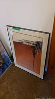 Framed watercolour painting leaning against wall showing full artwork and frame details.