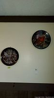 Two pottery plates mounted on a wall, showing their size and arrangement.