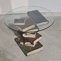 Full view of the book table showing stacked book base with removable glass top
