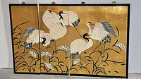 Front view of all four connected panels showing full crane scene on gold background
