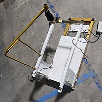 Full view of the New Joy quilting machine metal frame and attached wires, showing overall structure and controls.