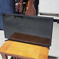 29-inch Samsung TV on a wooden surface, showing front view of screen and black frame with Samsung logo.