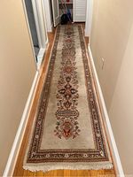 Full length view of narrow runner laid in hallway