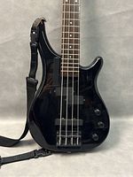 Close view of front body showing pickups, bridge and control knobs.