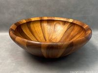 Side view of the staved acacia wood salad bowl showing the segmented wood pattern and smooth finish.
