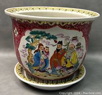 Front side view showing detailed hand painted figures and decoration on flower pot with matching saucer beneath.