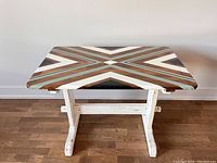 Top view of the wooden accent table showing geometric patterned surface in white, brown, and blue