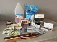 Full gel nail kit with all items displayed on table - polishes, lamp, removers, tools, Epsom salts