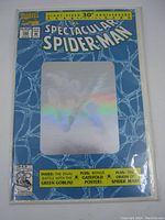 Front cover of The Spectacular Spider-Man No.189 comic book showing hologram on blue web patterned background.