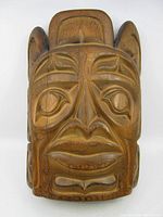 Front view of carved wood mask showing facial features