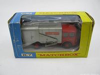 Photo of the Lesney Matchbox K-7 refuse truck toy inside original box with visible wear and damage to the box.